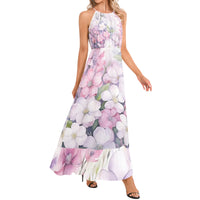 Women's flowy floral maxi dress featuring watercolor flowers in blush pink, lavender, and white with a halter neckline