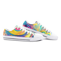 Low-top canvas shoes featuring a bold psychedelic abstract print in vibrant shades of blue, pink, purple, orange, and yellow. Modern designer sneakers with colorful swirling artwork, white laces, white rubber soles, and a contemporary streetwear aesthetic