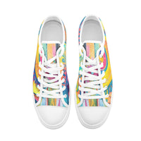 Low-top canvas shoes featuring a bold psychedelic abstract print in vibrant shades of blue, pink, purple, orange, and yellow. Modern designer sneakers with colorful swirling artwork, white laces, white rubber soles, and a contemporary streetwear aesthetic