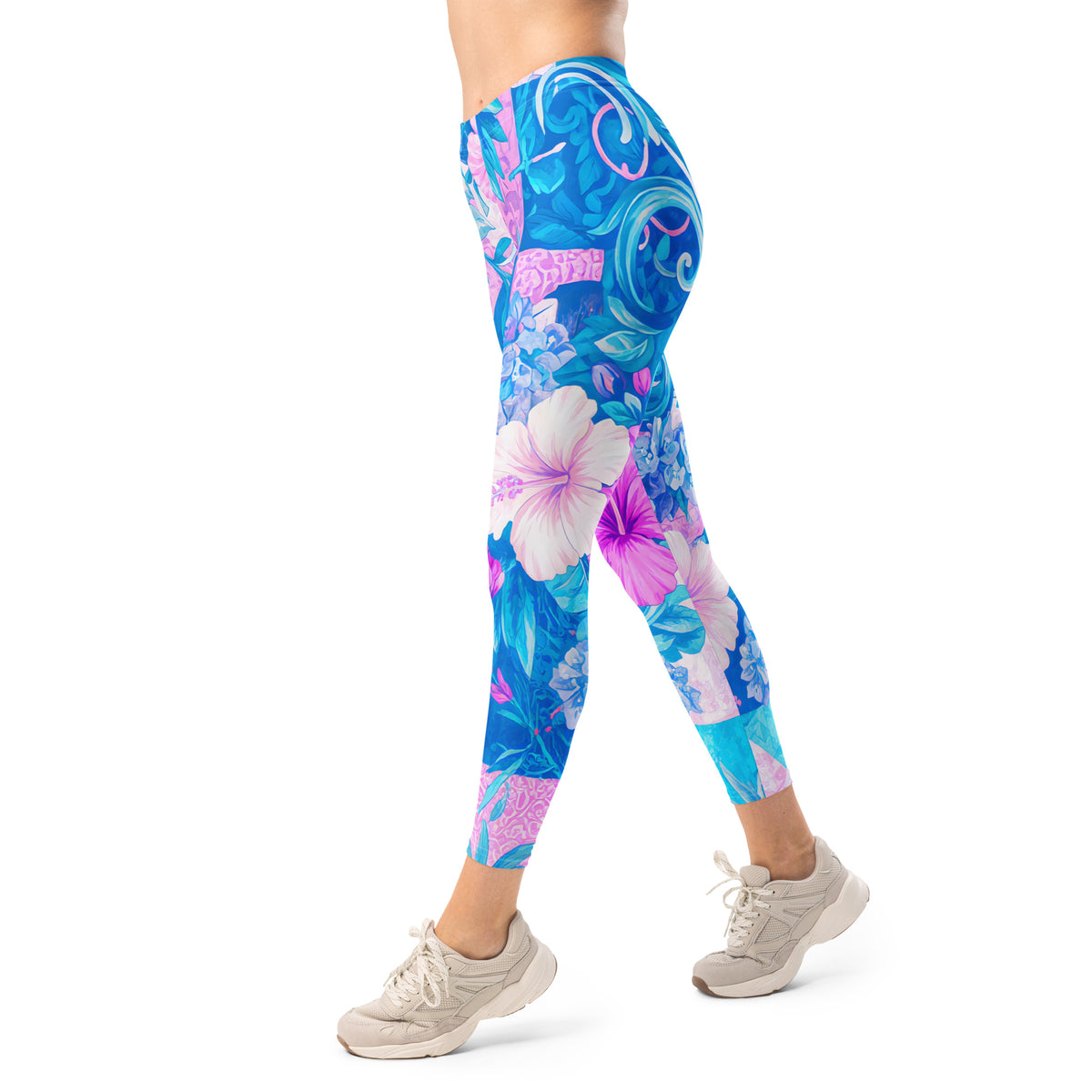 Tropical hibiscus floral leggings in vibrant blue and pink with a colorful botanical print, designed as island-inspired activewear and statement streetwear