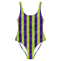 Women's one-piece swimsuit with vibrant purple and neon green vertical striped print and textured abstract design