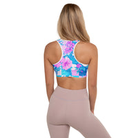Tropical hibiscus sports bra in vibrant blue with pink floral botanical print, featuring padded moisture-wicking fabric for stylish activewear and workout