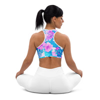 Tropical hibiscus sports bra in vibrant blue with pink floral botanical print, featuring padded moisture-wicking fabric for stylish activewear and workout