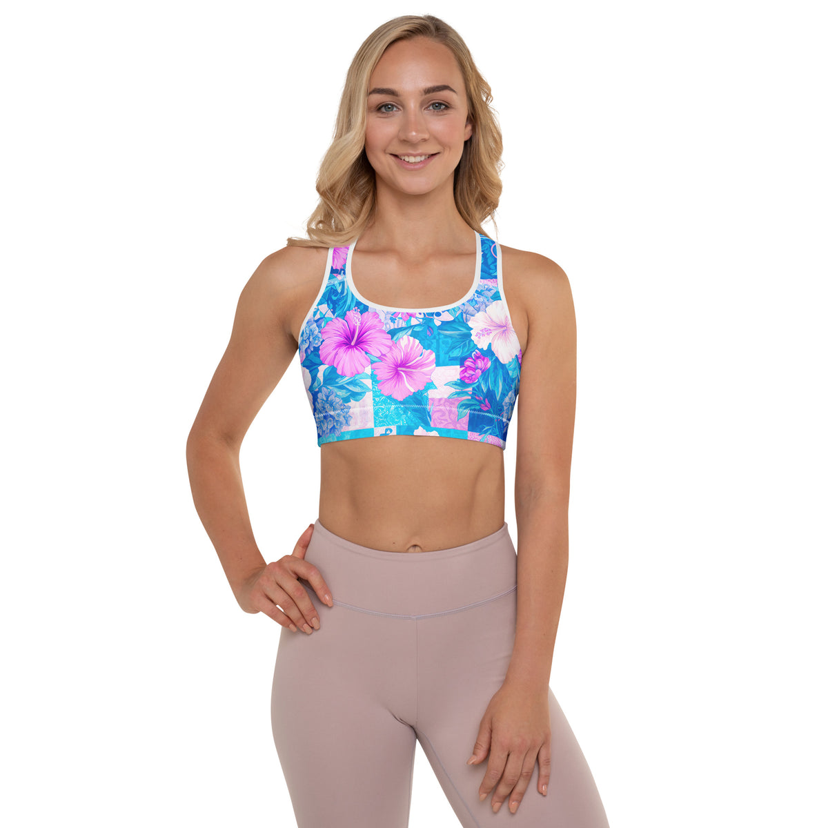 Tropical hibiscus sports bra in vibrant blue with pink floral botanical print, featuring padded moisture-wicking fabric for stylish activewear and workout