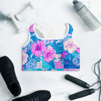 Tropical hibiscus sports bra in vibrant blue with pink floral botanical print, featuring padded moisture-wicking fabric for stylish activewear and workout