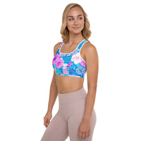 Tropical hibiscus sports bra in vibrant blue with pink floral botanical print, featuring padded moisture-wicking fabric for stylish activewear and workout