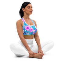 Tropical hibiscus sports bra in vibrant blue with pink floral botanical print, featuring padded moisture-wicking fabric for stylish activewear and workout