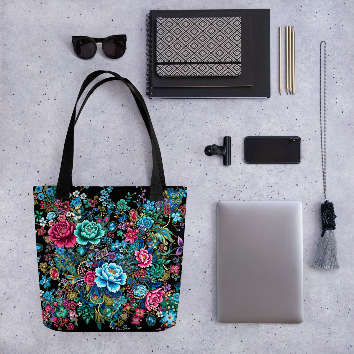 Tote bag with intricate multicolor floral pattern and jewel-inspired accents on a black background.