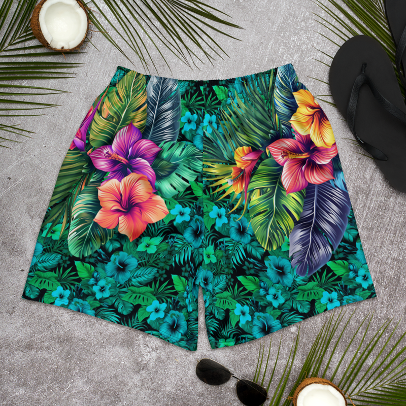 Tropical Tiki performance shorts featuring vibrant tiki mask artwork with hibiscus flowers and jungle leaves in bold tropical streetwear design