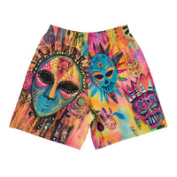 Long sports shorts featuring a vibrant psychedelic tribal mask print with expressive painted faces, decorative folk-art symbols, abstract shapes, brushstrokes, and colorful collage-like textures in turquoise, teal, coral, pink, magenta, orange, yellow, purple, black, and earthy tones. Unisex athletic design with a longer cut, elastic waistband, and bold artistic all-over pattern