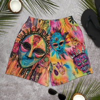 Long sports shorts featuring a vibrant psychedelic tribal mask print with expressive painted faces, decorative folk-art symbols, abstract shapes, brushstrokes, and colorful collage-like textures in turquoise, teal, coral, pink, magenta, orange, yellow, purple, black, and earthy tones. Unisex athletic design with a longer cut, elastic waistband, and bold artistic all-over pattern