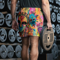 Long sports shorts featuring a vibrant psychedelic tribal mask print with expressive painted faces, decorative folk-art symbols, abstract shapes, brushstrokes, and colorful collage-like textures in turquoise, teal, coral, pink, magenta, orange, yellow, purple, black, and earthy tones. Unisex athletic design with a longer cut, elastic waistband, and bold artistic all-over pattern