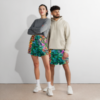 Tropical Tiki performance shorts featuring vibrant tiki mask artwork with hibiscus flowers and jungle leaves in bold tropical streetwear design