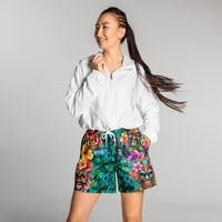 Tropical Tiki performance shorts featuring vibrant tiki mask artwork with hibiscus flowers and jungle leaves in bold tropical streetwear design