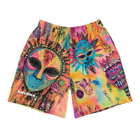 Long sports shorts featuring a vibrant psychedelic tribal mask print with expressive painted faces, decorative folk-art symbols, abstract shapes, brushstrokes, and colorful collage-like textures in turquoise, teal, coral, pink, magenta, orange, yellow, purple, black, and earthy tones. Unisex athletic design with a longer cut, elastic waistband, and bold artistic all-over pattern