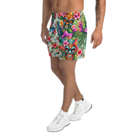 Tropical Tiki performance shorts featuring vibrant tiki mask artwork with hibiscus flowers and jungle leaves in bold tropical streetwear design