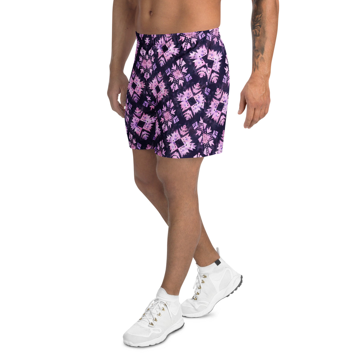 Deep purple athletic shorts with pastel pink geometric motifs and an all-over abstract tribal pattern