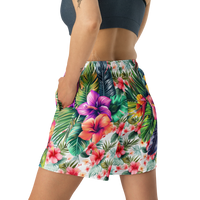 Tropical Tiki performance shorts featuring vibrant tiki mask artwork with hibiscus flowers and jungle leaves in bold tropical streetwear design