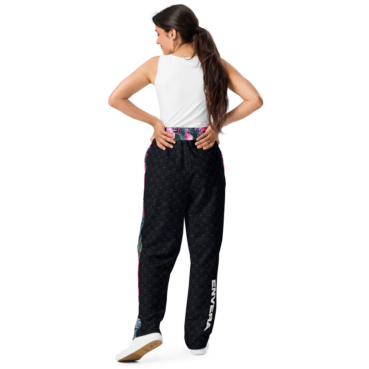 Vibrant Rebel tropical floral wide-leg joggers with vivid all-over pattern of hibiscus flowers and lush green leaves on a dark background