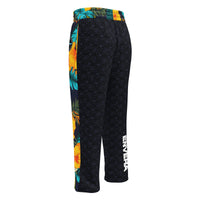 Vibrant Rebel tropical floral wide-leg joggers with all-over hibiscus and palm leaf print in orange, yellow, and teal on dark background