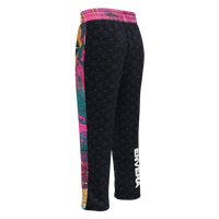 Unisex wide-leg joggers with abstract color block print in turquoise, magenta, deep pink, and gold accents