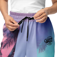 Unisex wide-leg joggers with neon palm tree print in pink, teal, lavender, and violet gradient tones