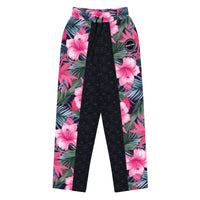 Vibrant Rebel tropical floral wide-leg joggers with vivid all-over pattern of hibiscus flowers and lush green leaves on a dark background