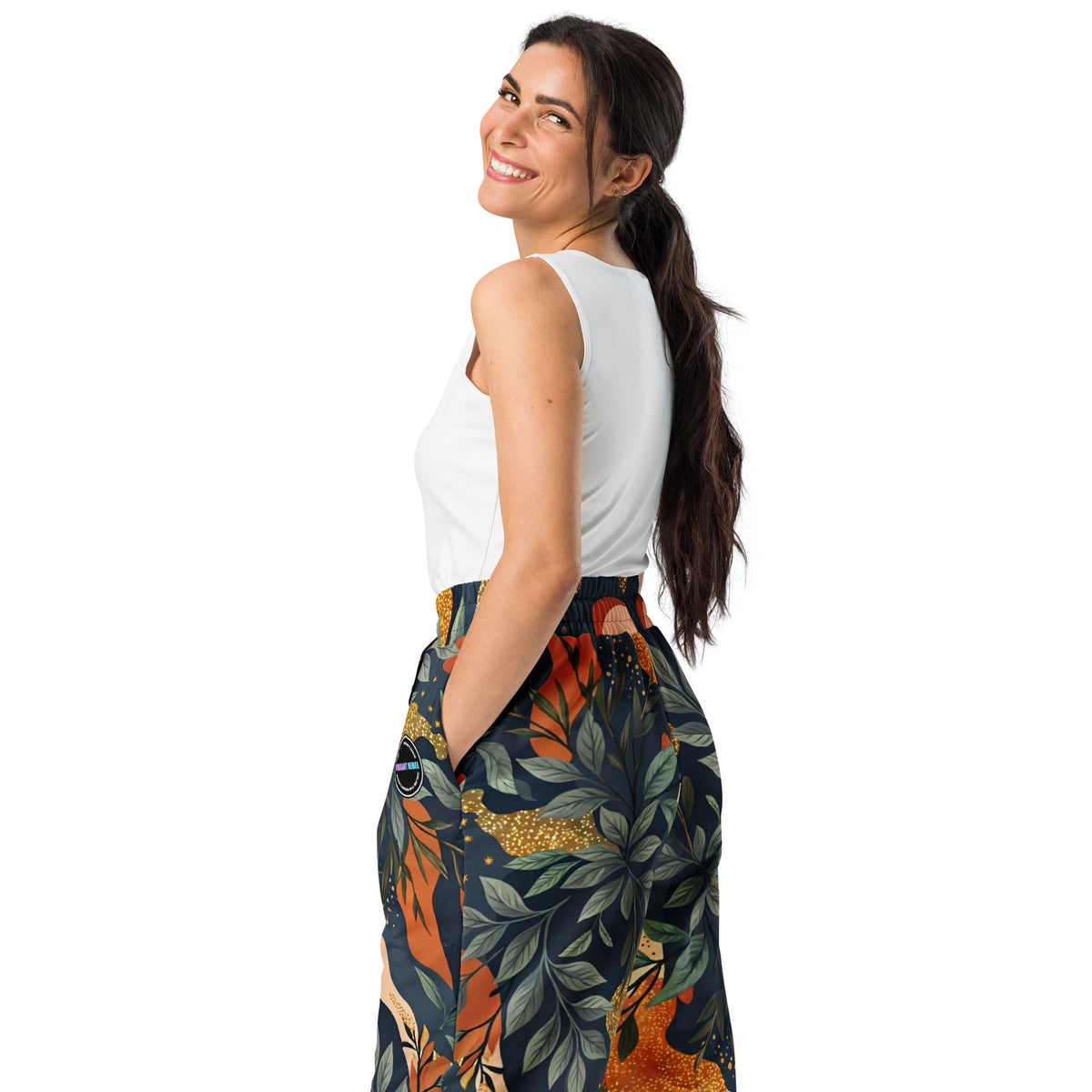 Unisex wide-leg joggers with abstract floral camouflage print in green and gold tones