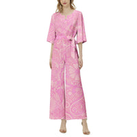 Women's retro floral wide leg jumpsuit with peach, pink, and lavender botanical print, dolman sleeves, and belted waist