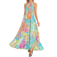 Women's tropical halter neck maxi dress with colorful turquoise hibiscus flower print and vibrant botanical design