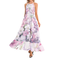 Women's flowy floral maxi dress featuring watercolor flowers in blush pink, lavender, and white with a halter neckline