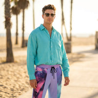Unisex wide-leg joggers with neon palm tree print in pink, teal, lavender, and violet gradient tones