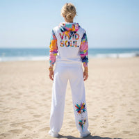 Unisex wide-leg joggers with colorful abstract paint splatter print in turquoise, coral, yellow, pink, and violet
