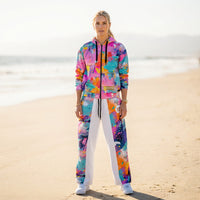 Unisex wide-leg joggers with colorful abstract paint splatter print in turquoise, coral, yellow, pink, and violet