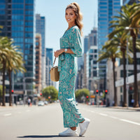 Women's pastel paisley jumpsuit with turquoise botanical print, notch neckline, and flowing wide leg silhouette
