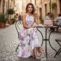 Women's flowy floral maxi dress featuring watercolor flowers in blush pink, lavender, and white with a halter neckline