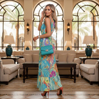Women's tropical halter neck maxi dress with colorful turquoise hibiscus flower print and vibrant botanical design